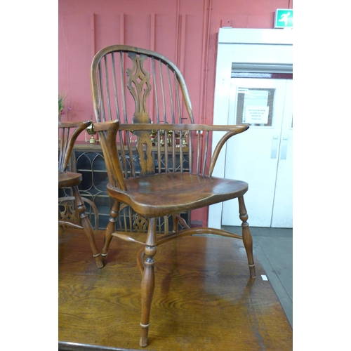 18 - A Gothic style oak x-frame refectory table and a set of six elm and oak Windsor chairs