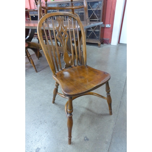 18 - A Gothic style oak x-frame refectory table and a set of six elm and oak Windsor chairs