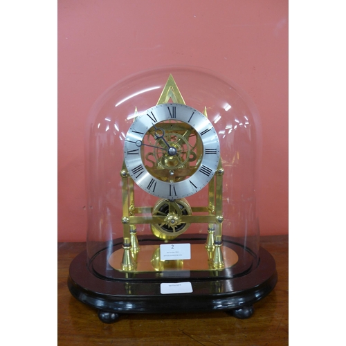 2 - A glass domed gilt metal six spoke fusee skeleton clock, on ebonised stand