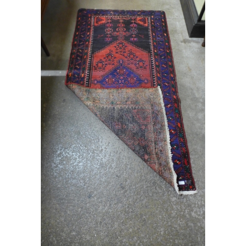 215 - An Eastern hand knotted red ground rug