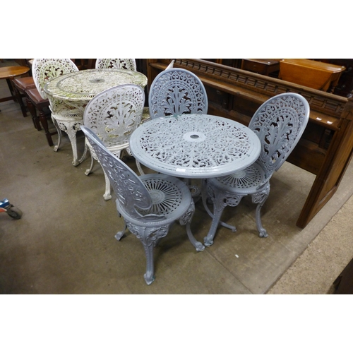 250 - A painted cast aluminium garden table and three chairs