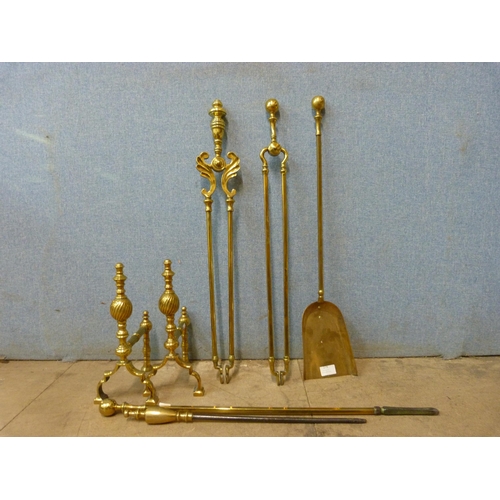 279 - A pair of 19th Century brass andirons and a companion set