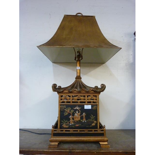 376 - An oriental style pagoda shaped black chinoiserie and gilt table lamp