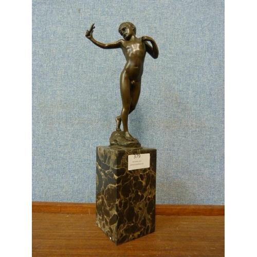 379 - A bronze figure of a cherub, on black marble socle, 33cms h