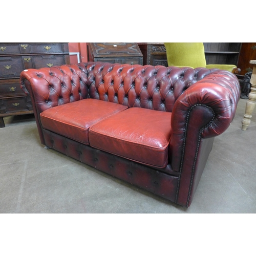 40 - An oxblood leather Chesterfield Settee