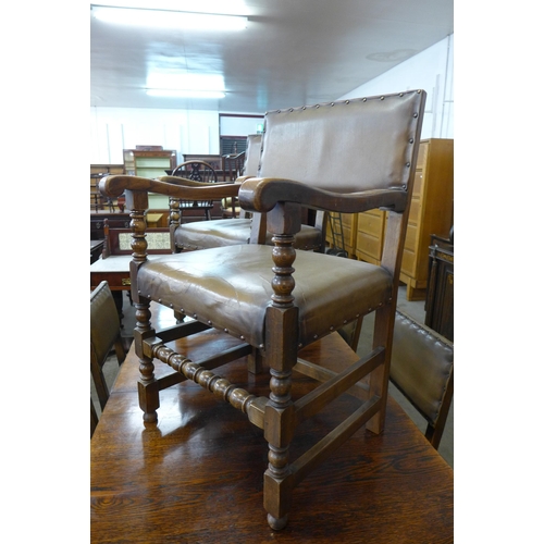 52 - A George III style oak pedestal dining table and a set of six oak and leather upholstered dining cha... 