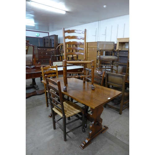 53 - An oak refectory table and a set of four elm rush seated ladderback chairs (one chair a/f)