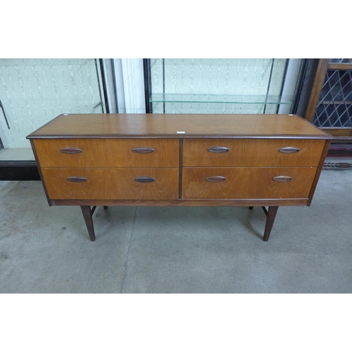 56 - A teak four drawer sideboard