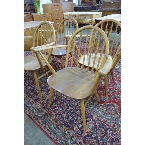 63 - A set of four Ercol Blonde elm and beech Windsor elbow chairs