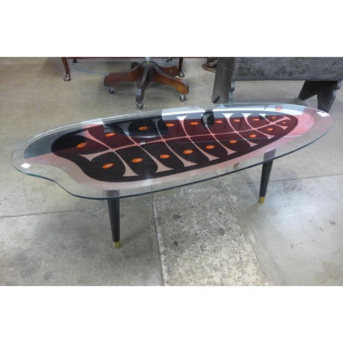 82 - An Italian ebonised and glass topped coffee table