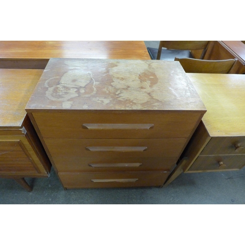 83 - A Meredew walnut desk, a teak chest of drawers and sideboard, a/f