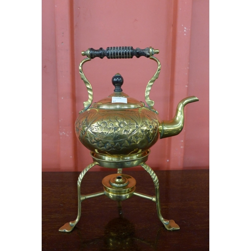 9 - An Arts and Crafts brass spirit kettle on stand