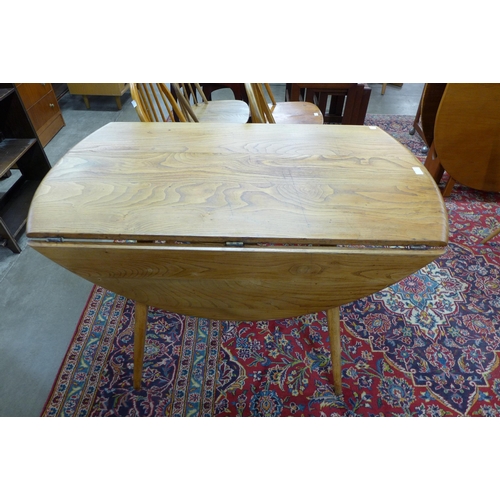 93 - An Ercol Blonde elm and beech Windsor drop leaf table