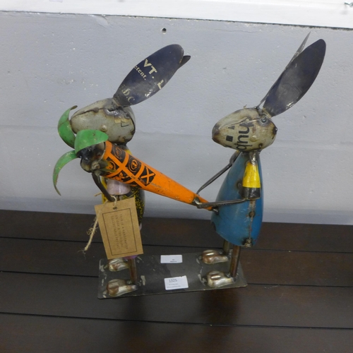 1325 - A pair of rabbits carrying a carrot in hand crafted reclaimed tin, H 39cms (MH623616)   #