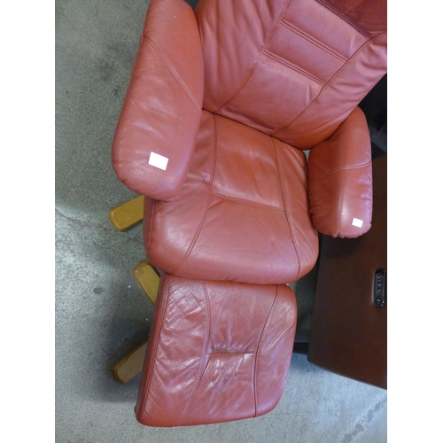 1510 - A red leather reclining armchair with footstool