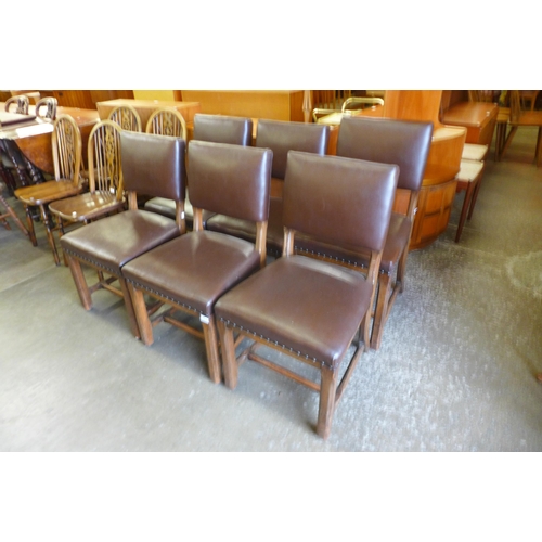 153 - A set of six Arts and Crafts oak and brown leather upholstered chairs