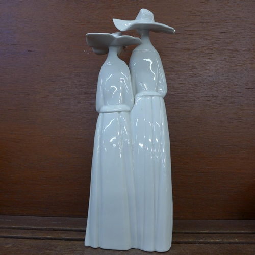 606 - A Lladro figure of two nuns, 34cm