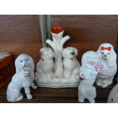 622 - A pair of small Beswick poodles, two pairs of Staffordshire dogs and a Staffordshire spill vase