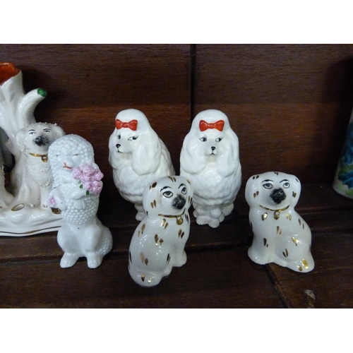 622 - A pair of small Beswick poodles, two pairs of Staffordshire dogs and a Staffordshire spill vase