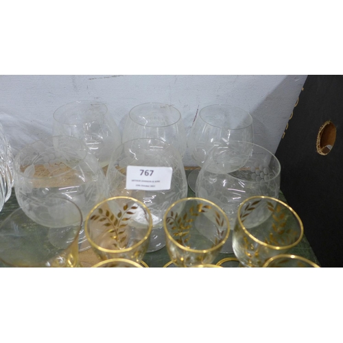 767 - A collection of mixed drinking glasses including six etched brandy glasses, nine liqueur glasses wit... 