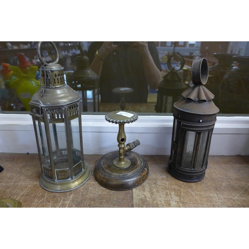 778 - A mounted brass gas burner, two lamps and two pairs of brass candlesticks