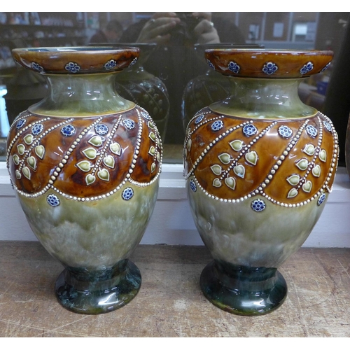 779 - A pair of Royal Doulton stoneware vases, impressed marks to base, 28.5cm, one a/f