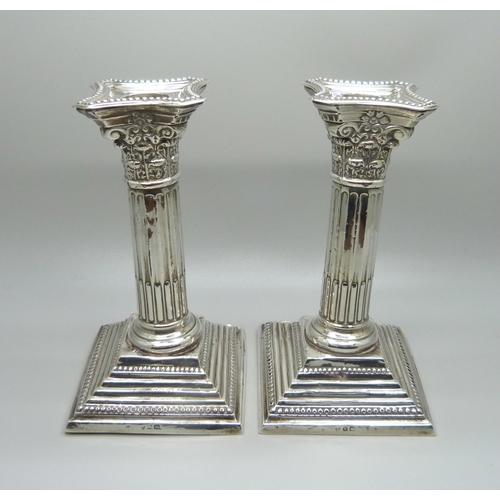 810 - A pair of silver candlesticks, 15.5cm, a/f