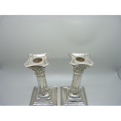 810 - A pair of silver candlesticks, 15.5cm, a/f