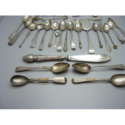 823 - A collection of silver spoons, etc., including a pair of 19th Century silver mustard spoons, 301g of... 