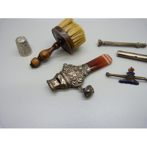 832 - An agate and silver set baby rattle, Birmingham 1910, lacking one bell, a silver posy holder, a whit... 