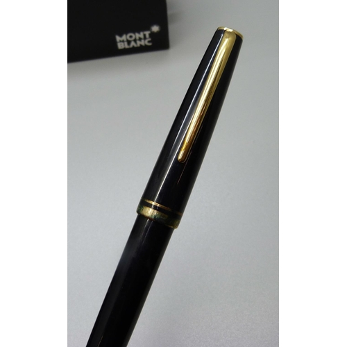 841 - A Mont-Blanc fountain pen with 14ct gold nib, box and papers and a pot of black ink