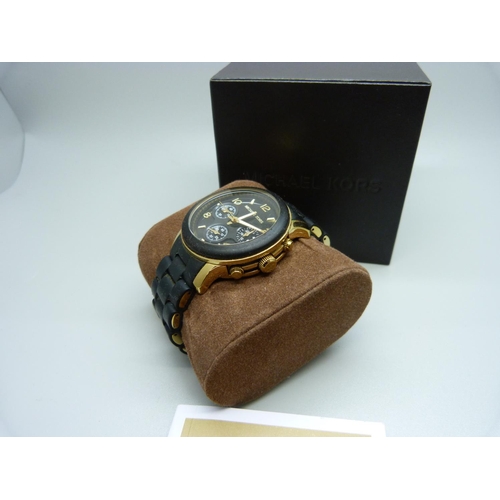 845 - A Michael Kors copper and black designer wristwatch, with box and spare links