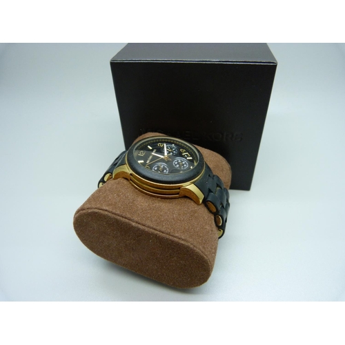 845 - A Michael Kors copper and black designer wristwatch, with box and spare links