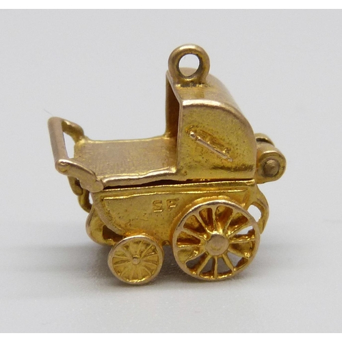 911 - A hallmarked 9ct gold pram charm, 3g