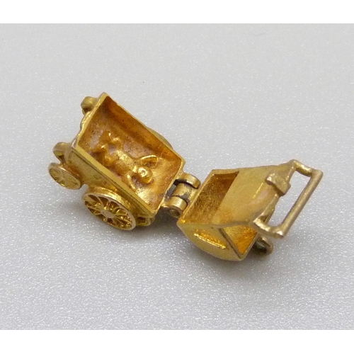 911 - A hallmarked 9ct gold pram charm, 3g