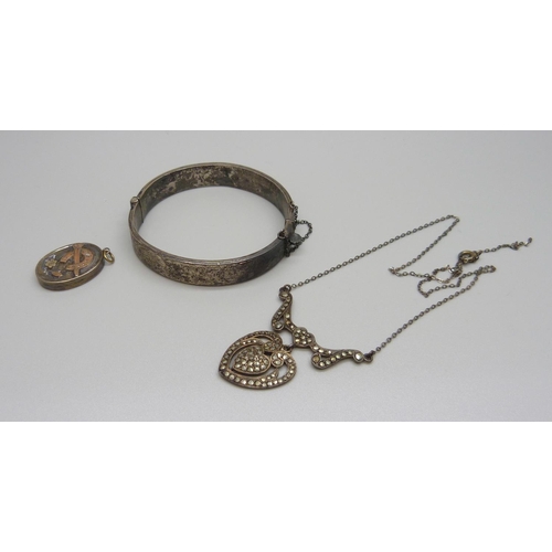 916 - A Victorian silver locket with gold applied horseshoe, a silver bangle and a silver and marcasite ne... 