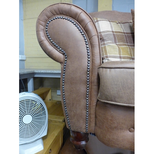 1393 - A County tan upholstered and studded love seat* this lot is subject to VAT