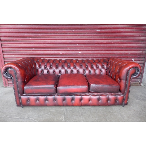 105a - A red leather Chesterfield three seater sofa