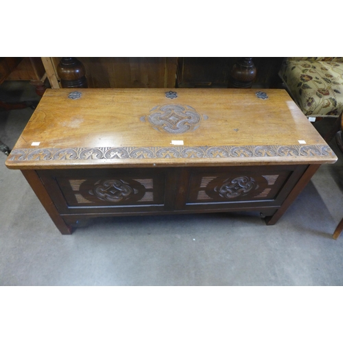 149 - A carved walnut blanket box