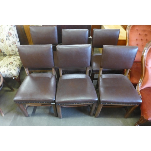 153 - A set of six Arts and Crafts oak and brown leather upholstered chairs