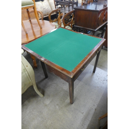 169 - A George III mahogany rectangular fold over games table