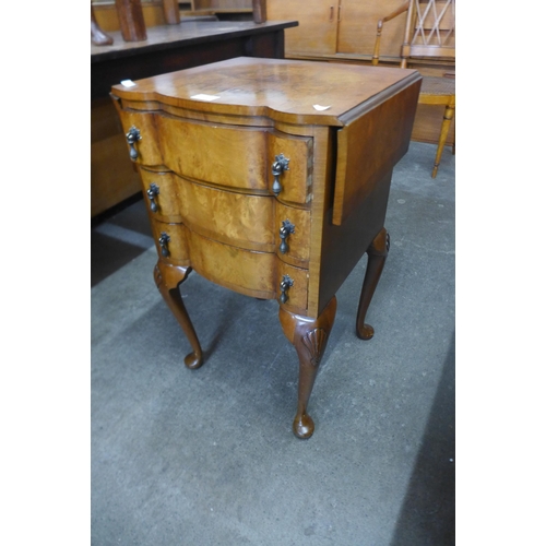 176 - A small walnut drop leaf chest of drawers