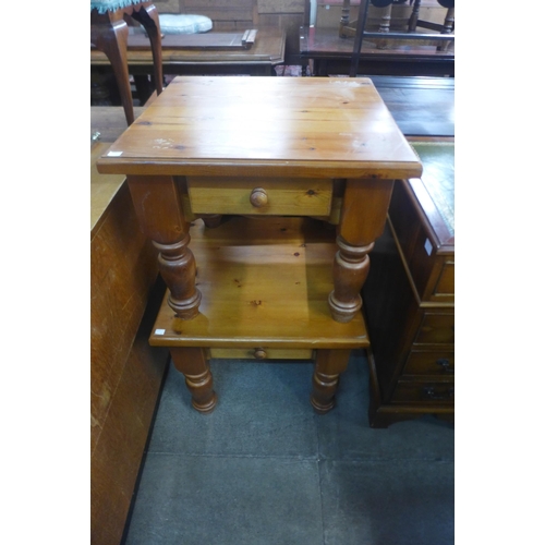 182 - A pair of pine single drawer lamp tables