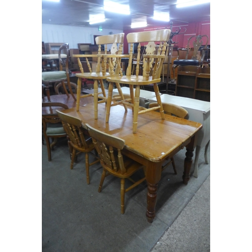 190 - A pine two drawer farmhouse kitchen table and six beech chairs