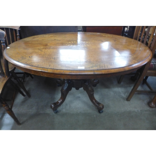 195 - A Victorian inlaid walnut oval tilt top loo table