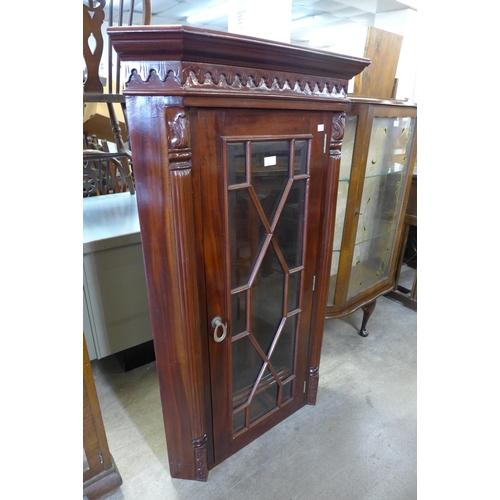 209 - A mahogany corner cabinet