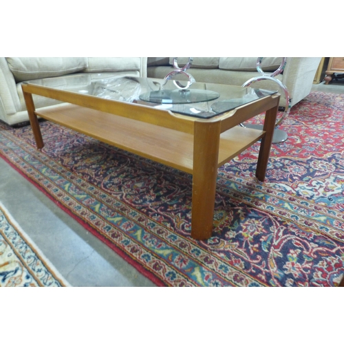 21 - A Myer teak and glass topped coffee table