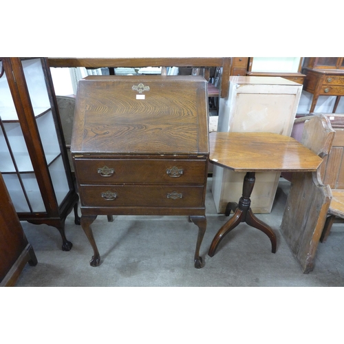 217 - An oak bureau and a Victorian mahogany tripod table