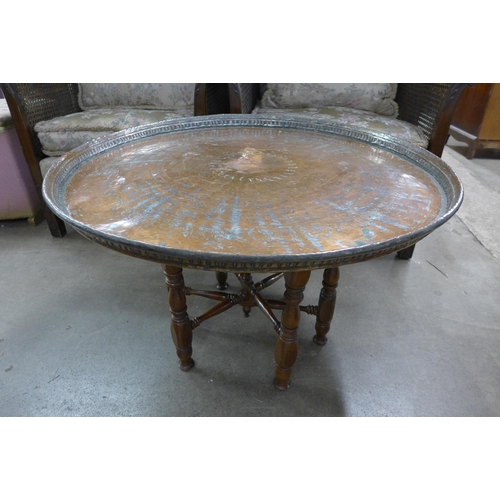 228 - An eastern copper plated folding occasional table