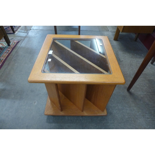 26 - A teak and glass topped coffee table/magazine rack